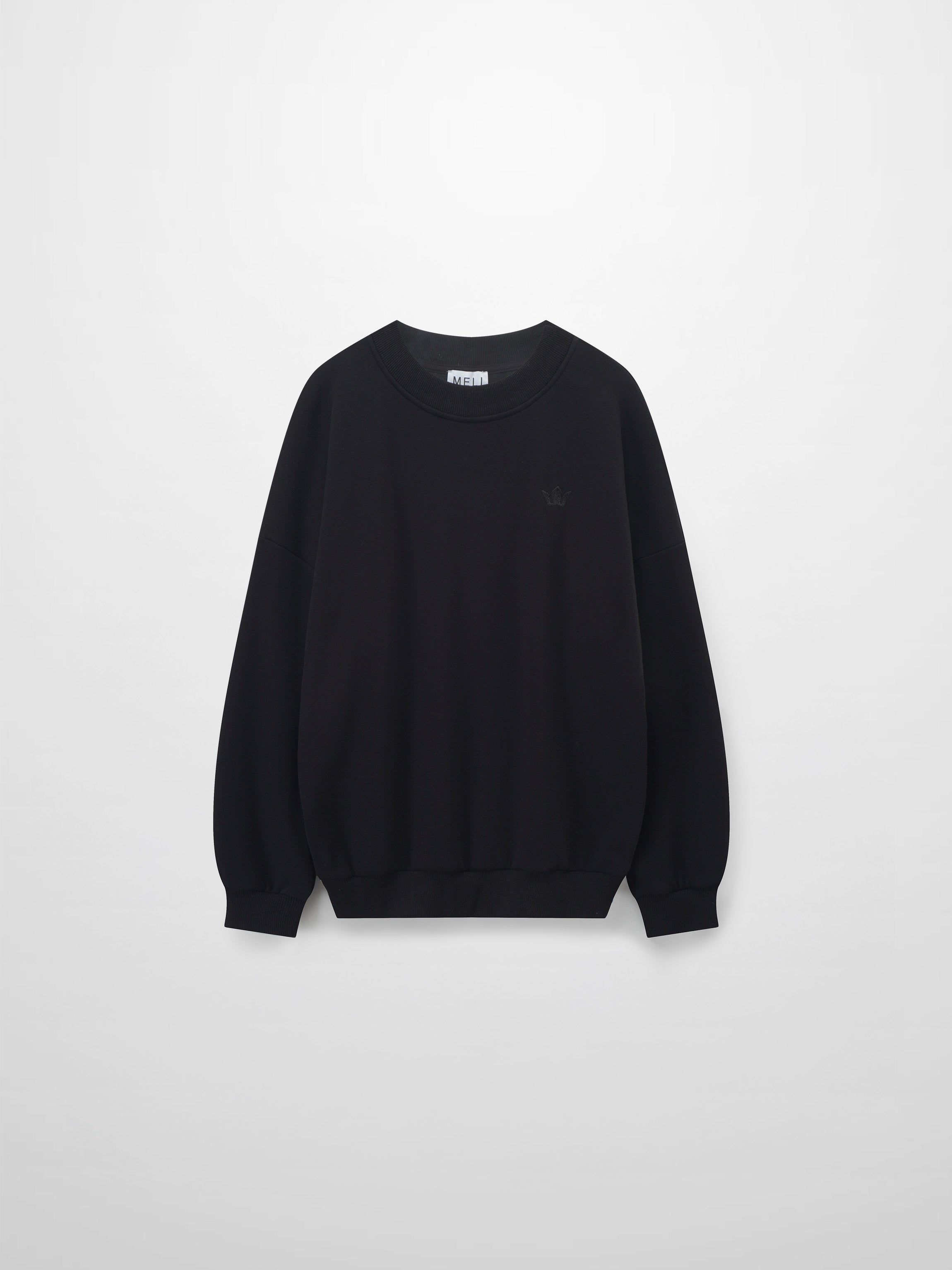 A full, front view of the black sweatshirt. The image shows the ribbed collar, cuffs, and hem, along with the subtle, black-on-black embroidered logo on the chest and a white tag inside the neckline.