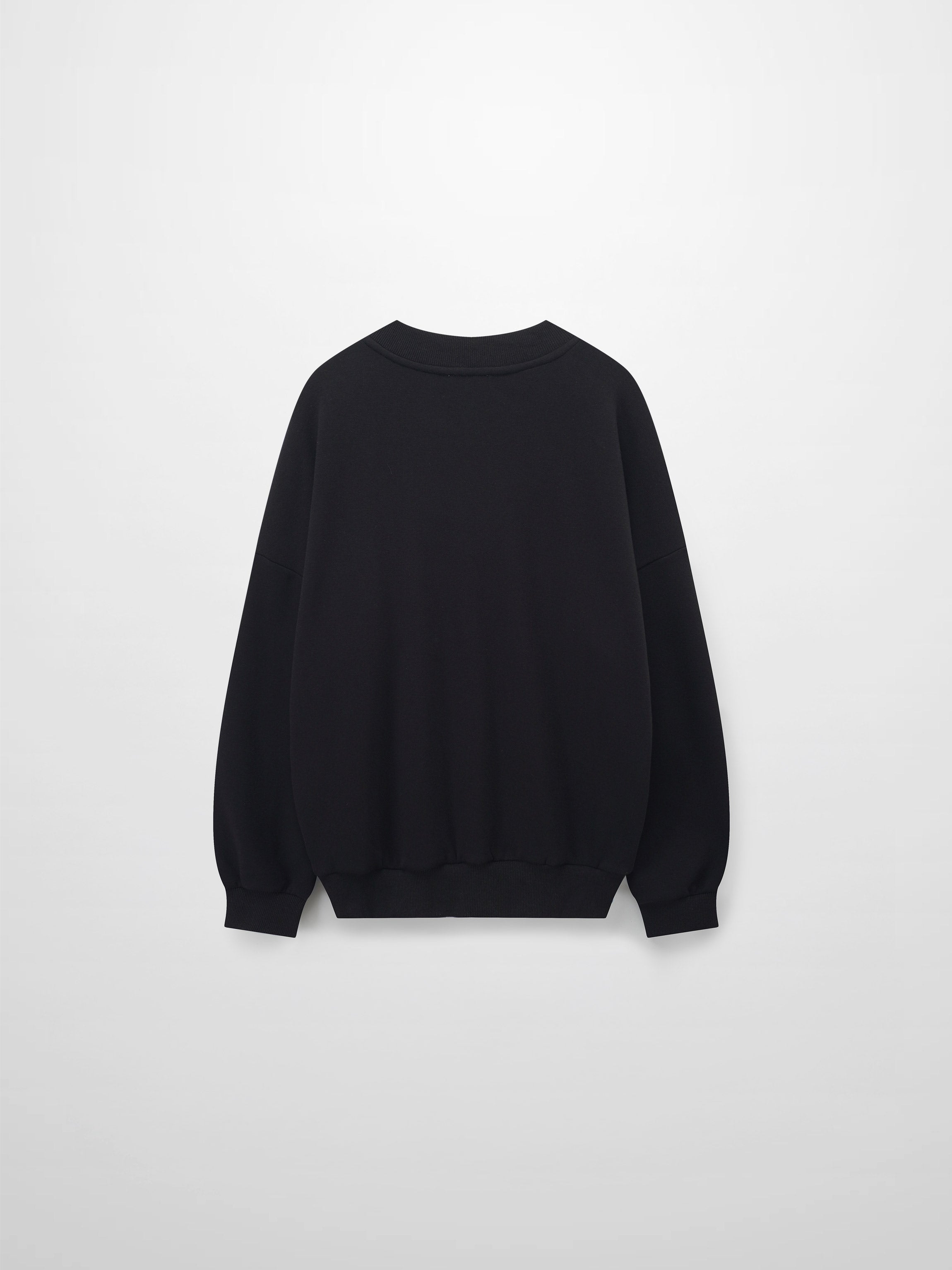 A full, back view of the black sweatshirt. The image shows the plain back of the garment, with its ribbed crewneck collar, sleeve cuffs, and bottom hem all visible.