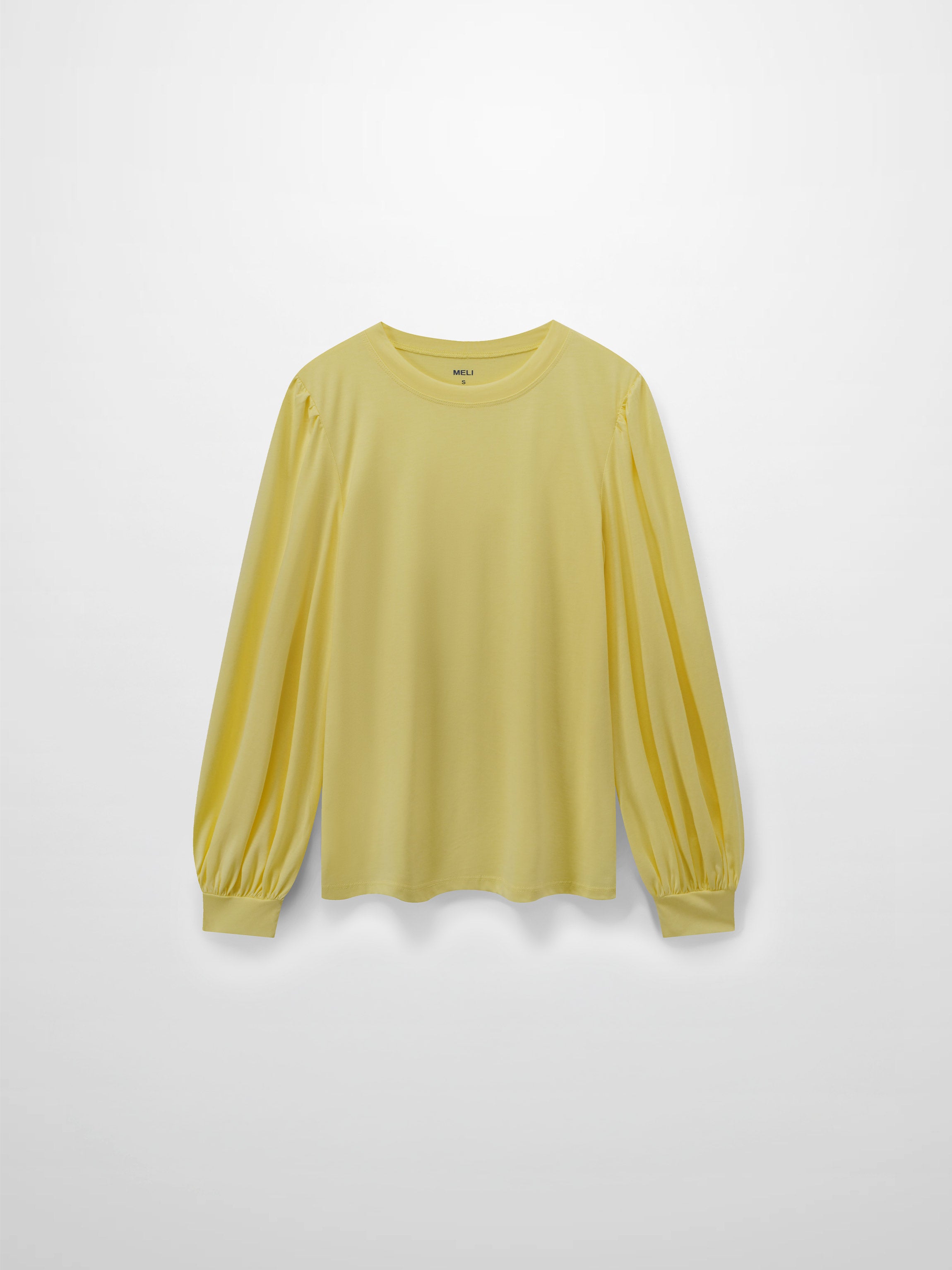 A full, front view of the pale yellow, long-sleeved shirt. It shows the puffed shoulders and voluminous sleeves that gather into fitted cuffs.