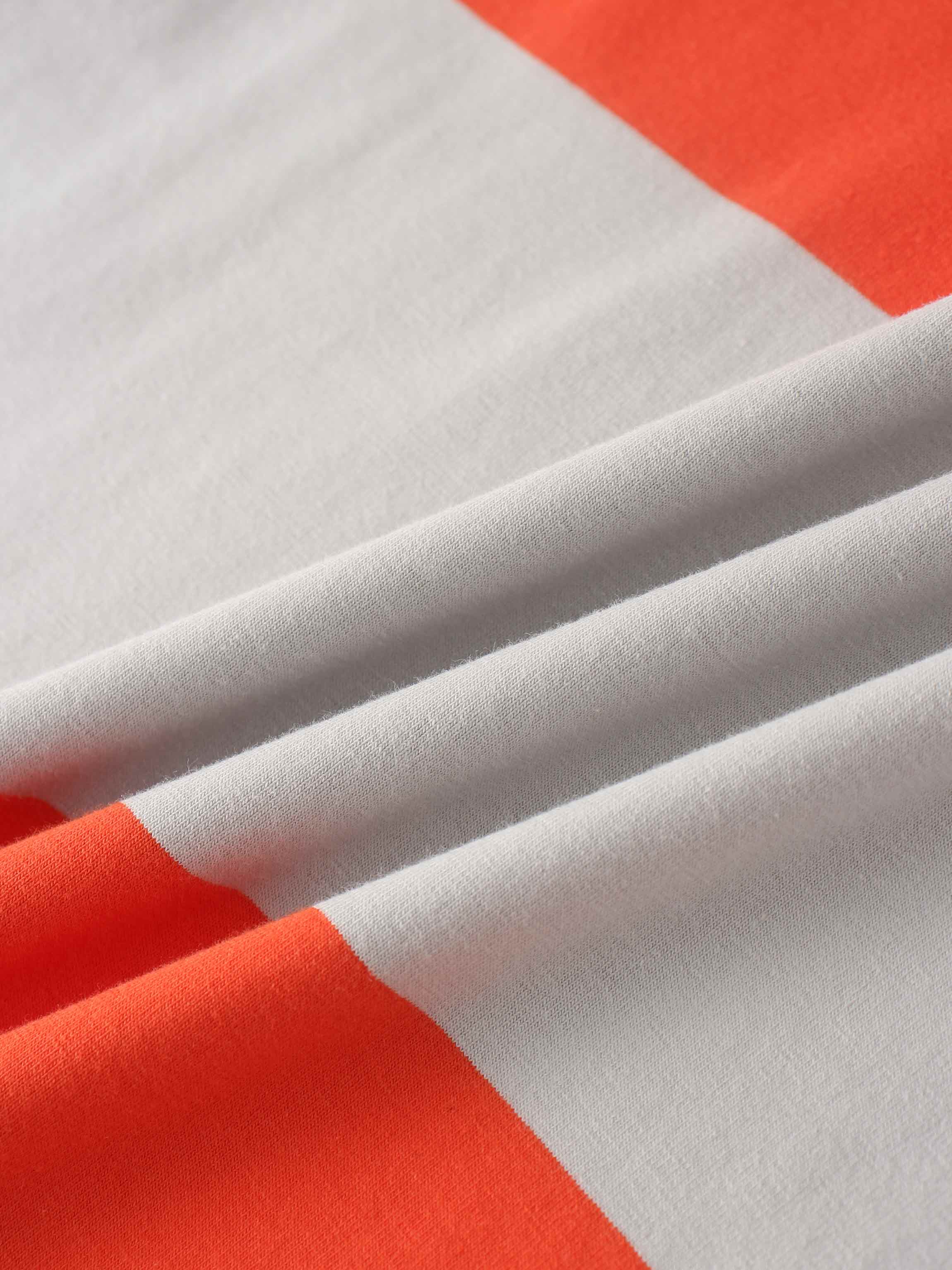 Orange and off-white striped fabric with visible texture.