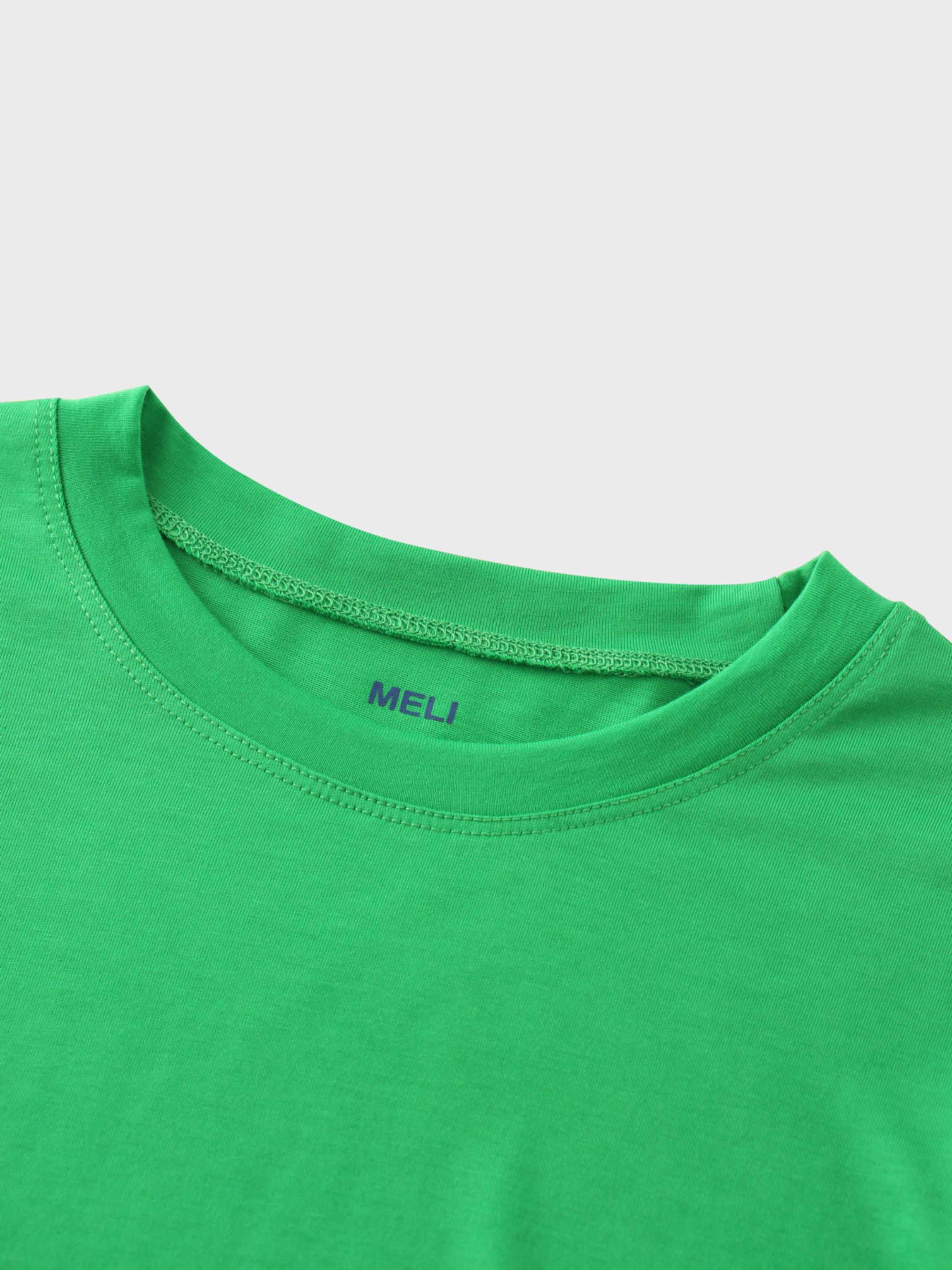 A close-up of the crewneck collar of the vibrant green t-shirt. On the inside, the brand name "MELI" is printed directly onto the fabric in blue.