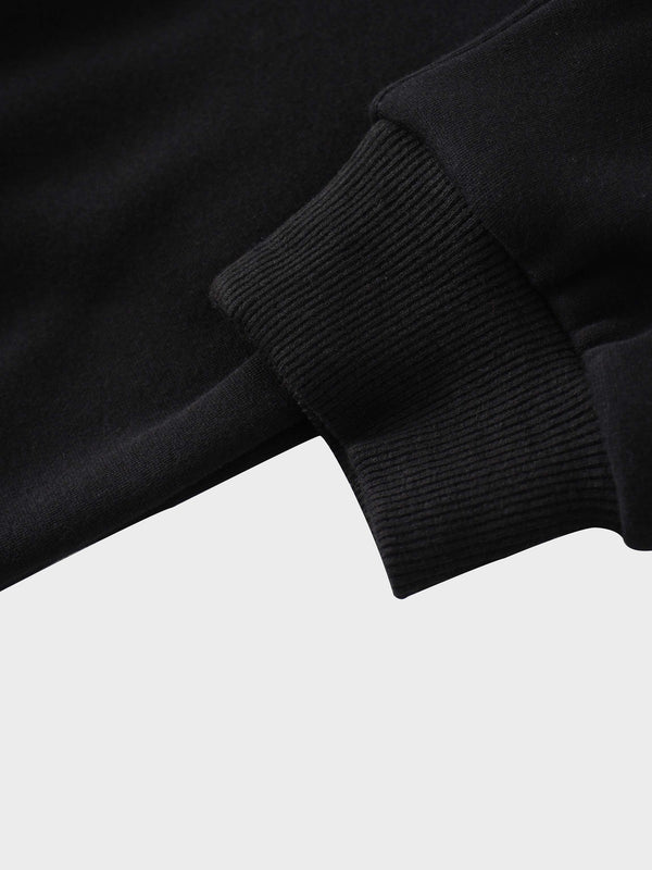 A full, front view of the black sweatshirt. The image shows the ribbed collar, cuffs, and hem, along with the subtle, black-on-black embroidered logo on the chest and a white tag inside the neckline.